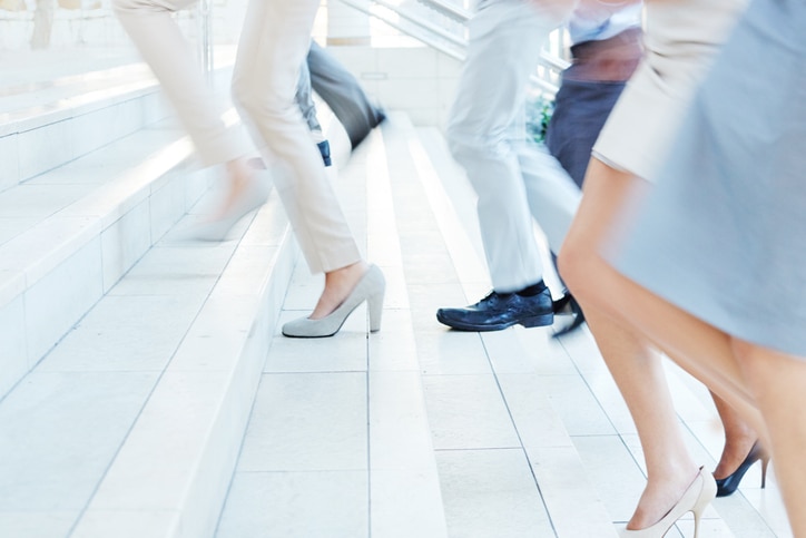 Cropped shot of businesspeople rushing up the stairs