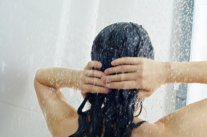 a beautiful girl standing at the shower