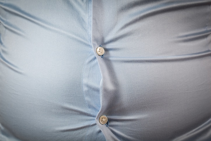 close up of tight shirt, fat man's upper body, unsuccessful dieting and eating wrong foods, diet concepts