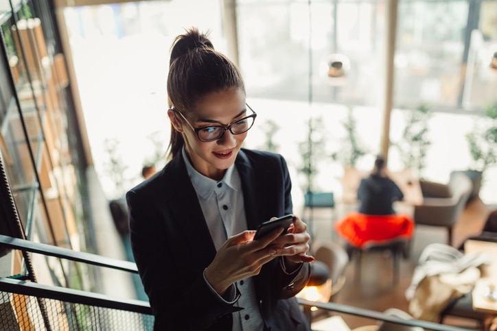 Top view of young businesswoman using technology.