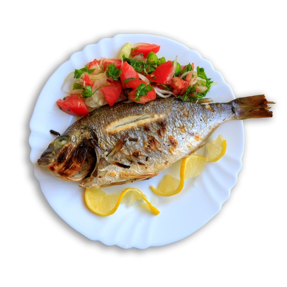 Roasted sea bream fish with lemon slices and salad