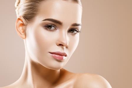 Beautiful woman healthy skin care concept portrait close up on beige background. Studio shot.