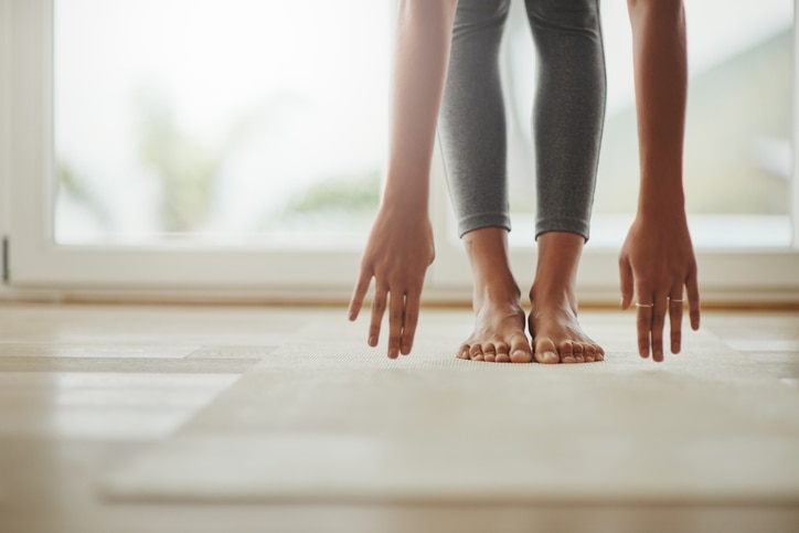 Cropped shot of a young woman practicing yoga at home