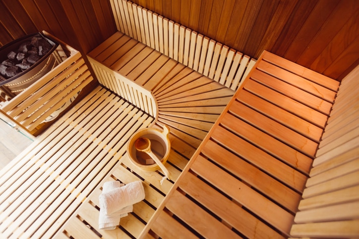 Interior of a wooden sauna room,with towels,bucket and ladle, view from the top