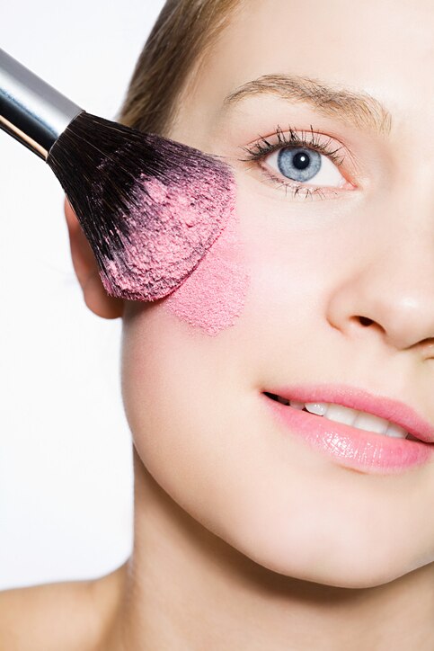 Woman with blusher on cheek