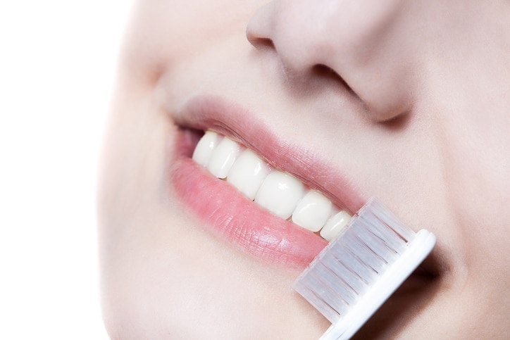 Beautiful woman with toothbrush. Dental care background.