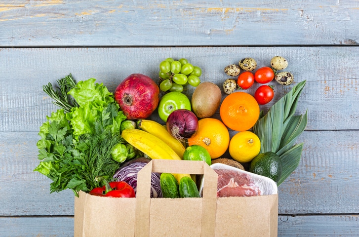 Healthy food background. Paper bag with healthy food