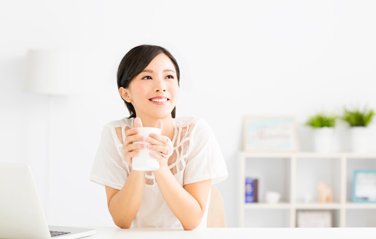 young Woman drinking  coffee in living room