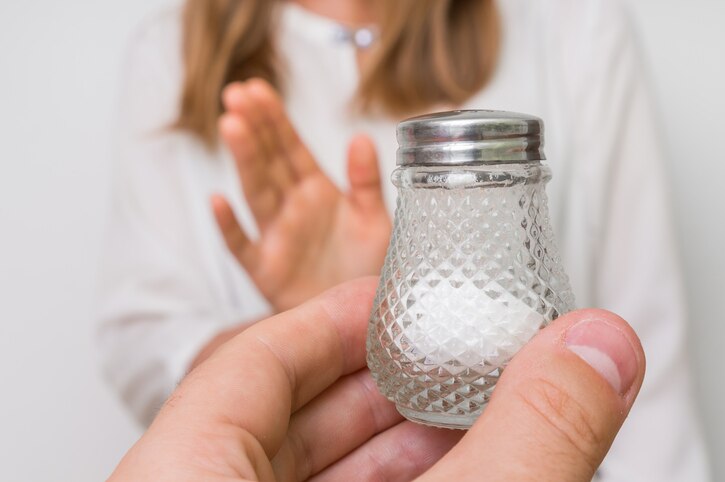 Woman refusing salt using gesture stop - health care concept