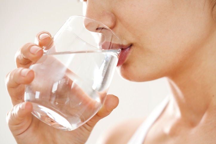 Young woman drinking  glass of water