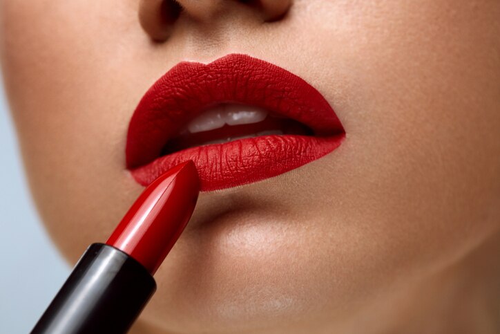 Red Lips. Closeup Of Woman Face With Bright Red Matte Lipstick On Full Lips. Beautiful Girl Applying Rouge Lipstick OnmSexy Soft Plump Lip. Beauty Cosmetics And Makeup Concept. High Resolution Image