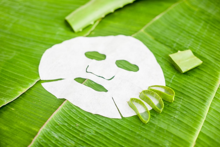 Sheet Mask with aloe on a background of banana leaf. Organic cosmetics concept. Natural cosmetics concept