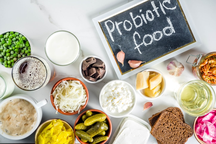 Super Healthy Probiotic Fermented Food Sources, drinks, ingredients, on white marble background copy space top view