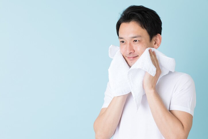 portrait of young asian man isolated on blue background