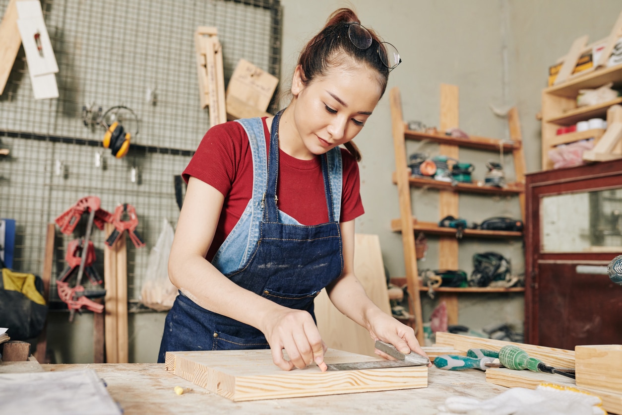 A person working on a piece of wood

Description automatically generated with medium confidence